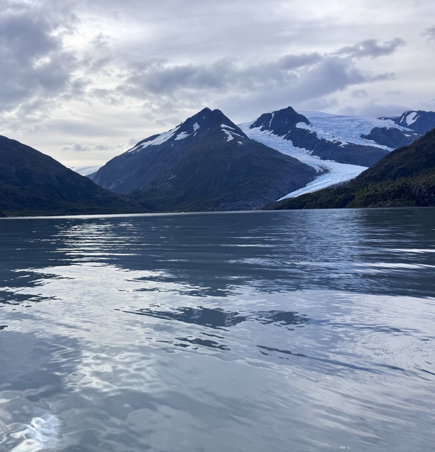Portage Lake beneath snow-covered mountains and a glacier